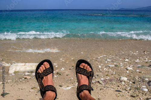 Feet on the beach in the waves. Albania