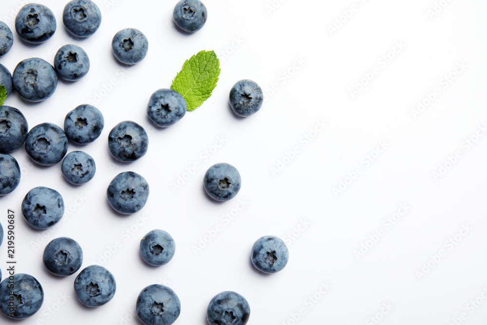 Flat lay composition with tasty blueberry and space for text on white background Flat lay composition with tasty blueberry and space for text on white background