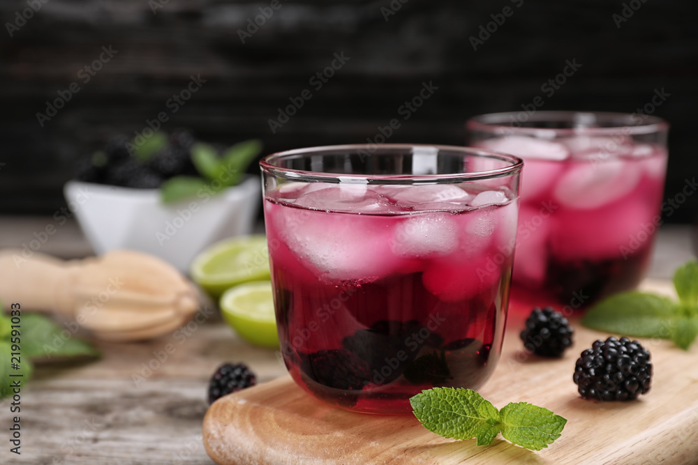 Glasses with iced blackberry lemonade on table Glasses with iced blackberry lemonade on table