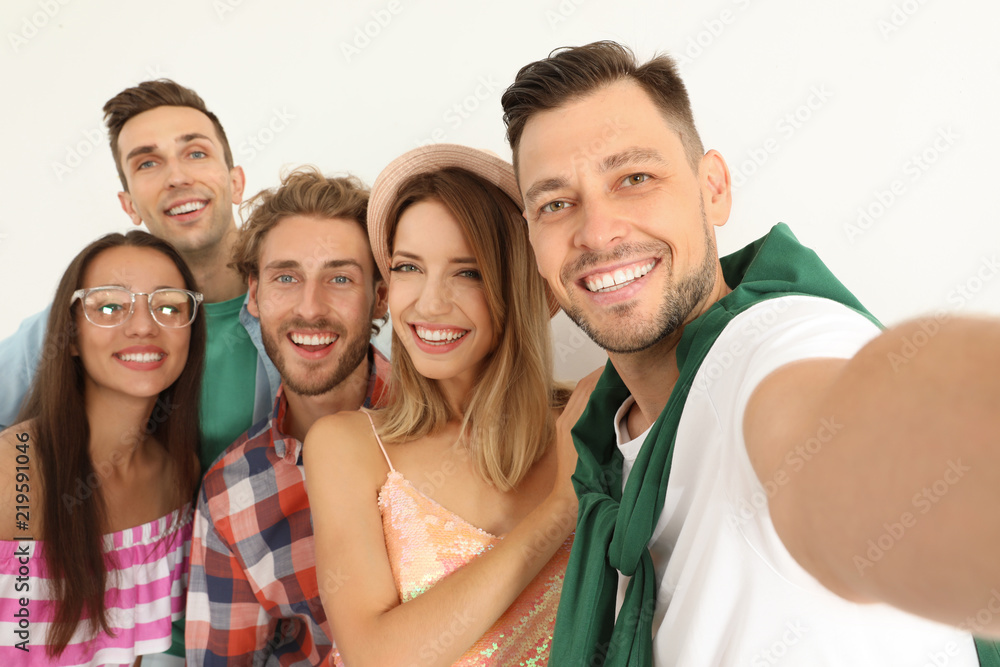 Group of happy young people taking selfie on white background Group of happy young people taking selfie on white background