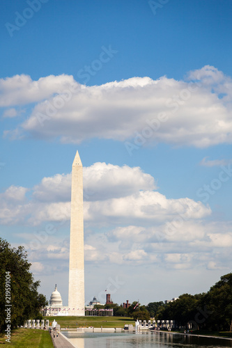 Washington Monument and US Capitol Building with Lincoln Memorial Reflecting Pool in Foreground and Blue Sky with Clouds