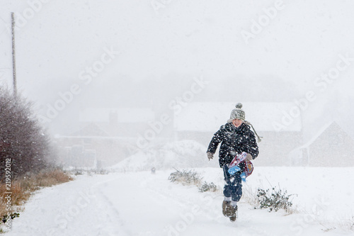 boy running home in snow storm
