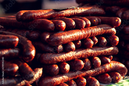 Hungarian venison sausage at the fair. Pile of deliciously stacked regional homemade sausages.