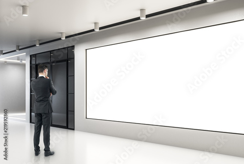 Businessman looking at empty poster