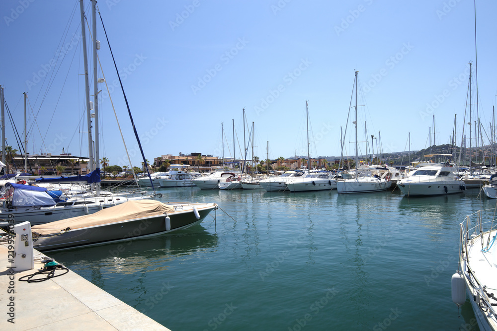 Yachts in the harbor on a sunny day. Copy space