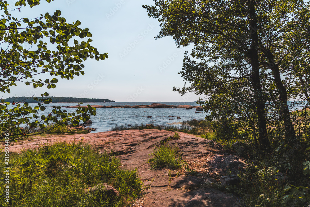 Helsinki Finland, sunny summer day at the shore looking from the woods
