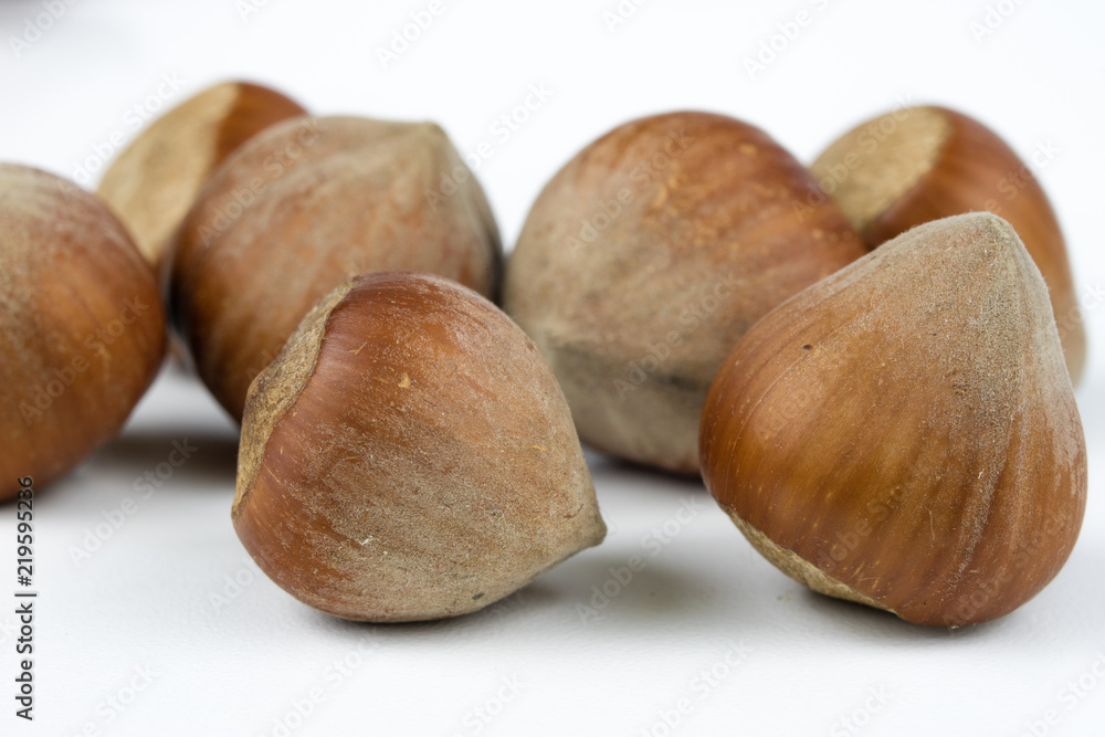 Hazelnuts in shell on a kitchen table. Hazel fruit as an addition to kitchen dishes. Hazelnuts in shell on a kitchen table. Hazel fruit as an addition to kitchen dishes.