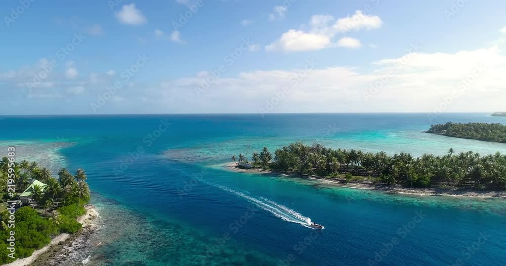 small island in a lagoon with a motor boat small island in a lagoon with a motor boat