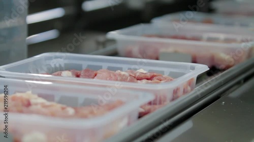 Packaging meat on the production line at the factory