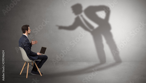 Photography Businessman staying and offering stuffs to a shadow businessman