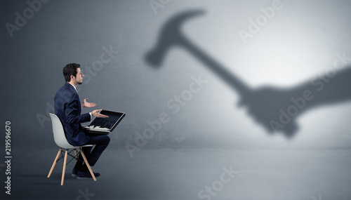 Fotografie Small businessman staying and offering stuffs for an armed shadow hand