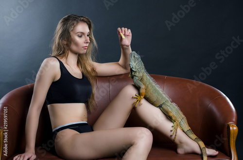 sexy girl fnd green iguana in the studio

