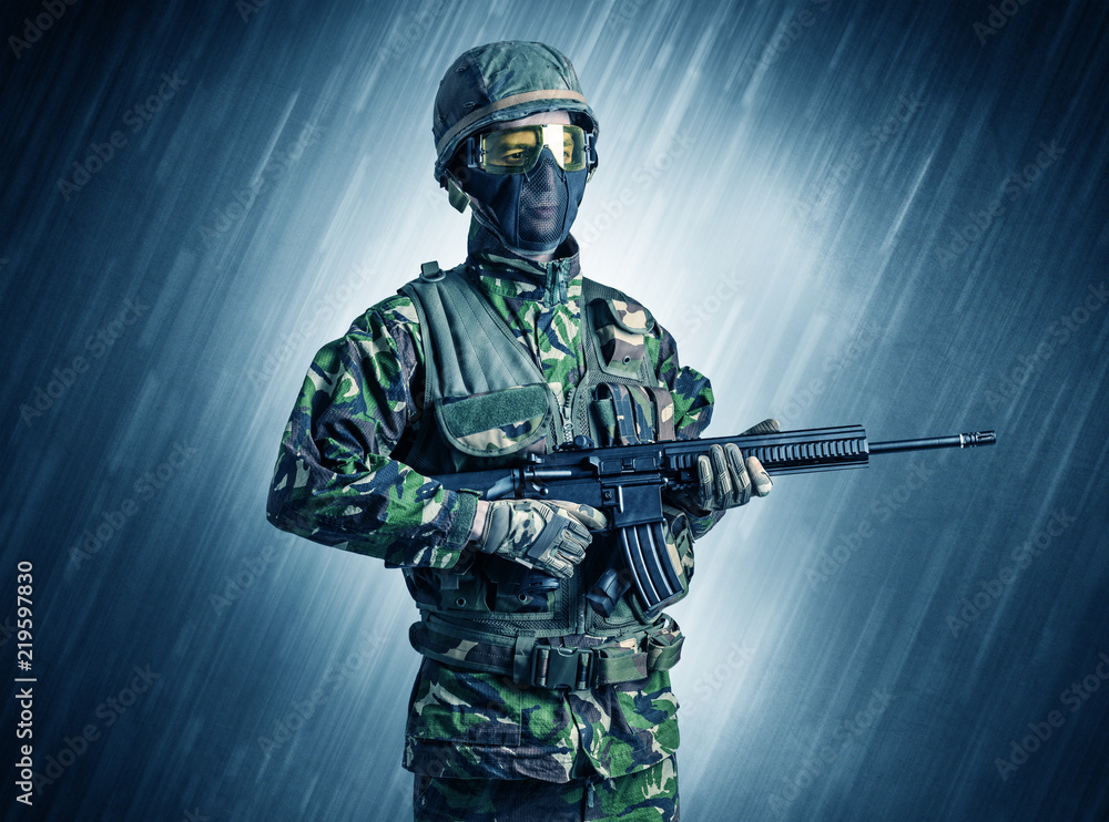 Armed soldier standing in rainy weather
Armed soldier standing in rainy weather