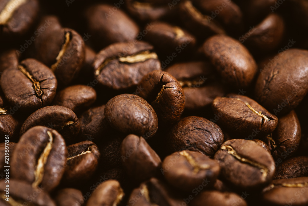 Coffee beans roasted on a wooden table with much of beans with a great aroma