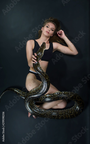 Perfect portrait sensual girl and python in the studio 