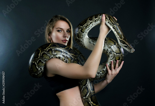 Beautiful girl and giant snake in the studio 