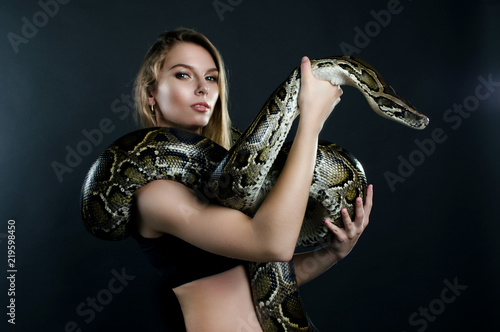 Beautiful girl and giant snake in the studio 