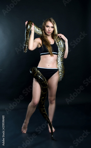 perfect girl and giant python in the studio   © s72677466