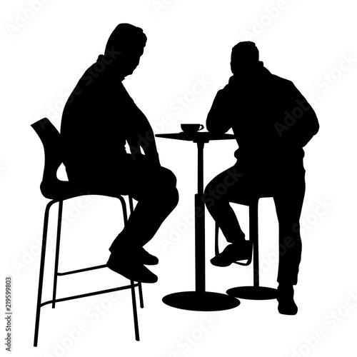 Two mans silhouette sitting at a table in the cafe, bar, restaurant or pub