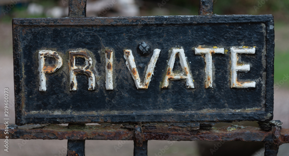 Private sign with rusted white letters