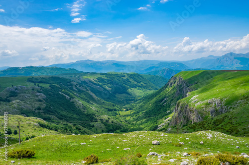 Beautiful green meadows stretched among the picturesque mountains.