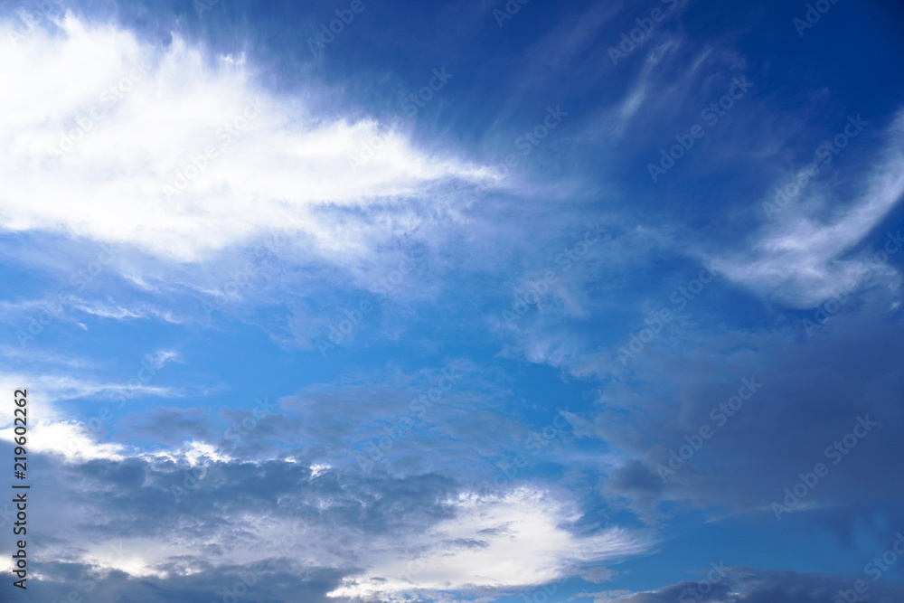 Obraz premium Beautiful white and gray clouds against the blue sky. Summer and autumn day with a view from the airplane to the atmosphere. Stock Photo for design