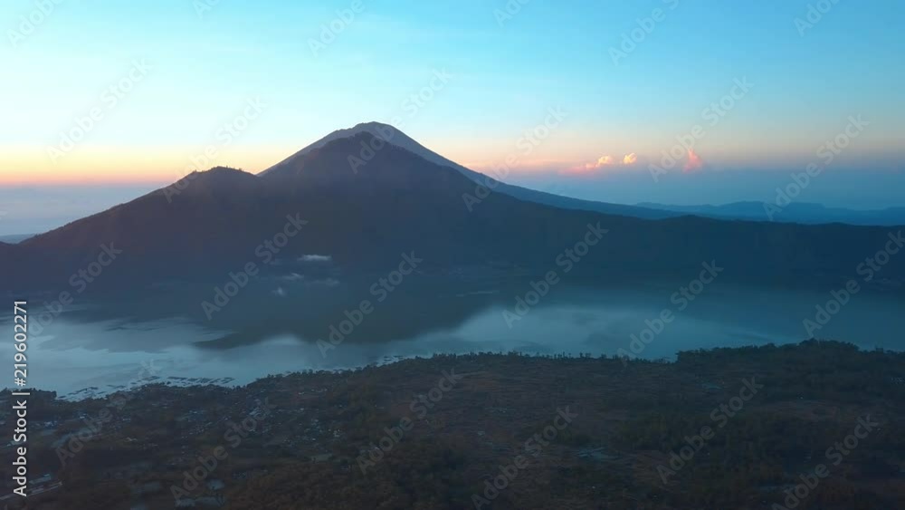 Beautiful sunrise in tropical island with mountains on background Beautiful sunrise in tropical island with mountains on background