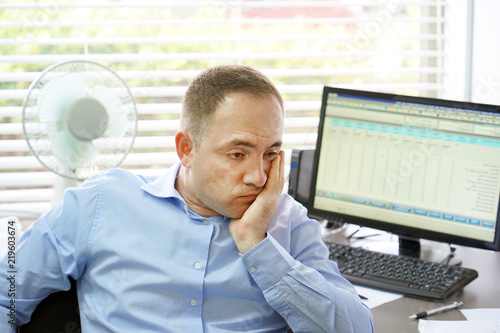 A lonely sad businessman is depressed and separated from problems in him personal life. Close-up of an office worker is unhappy. The concept of loneliness and loss of love. photo