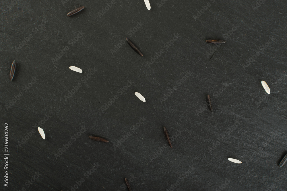 Raw Black Wild Rice on Dark Stone Background Raw Black Wild Rice on Dark Stone Background
