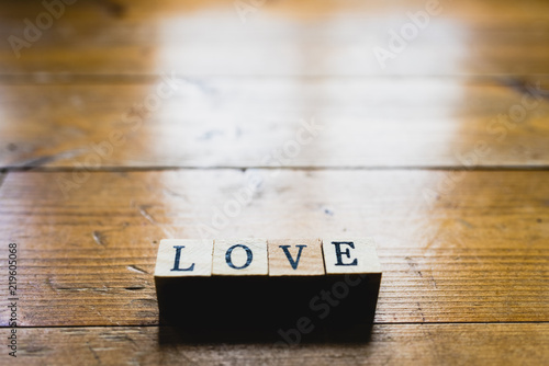 Word love on wooden background and copy space