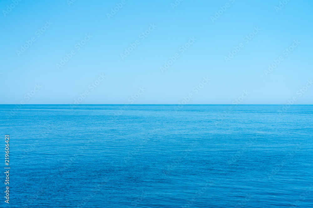 Sea and the cloudless blue sky, flowing into the horizon