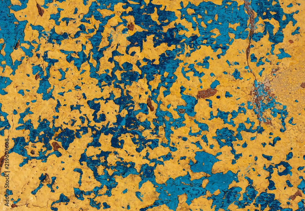 background. original cracked plaster painted in blue and yellow colors