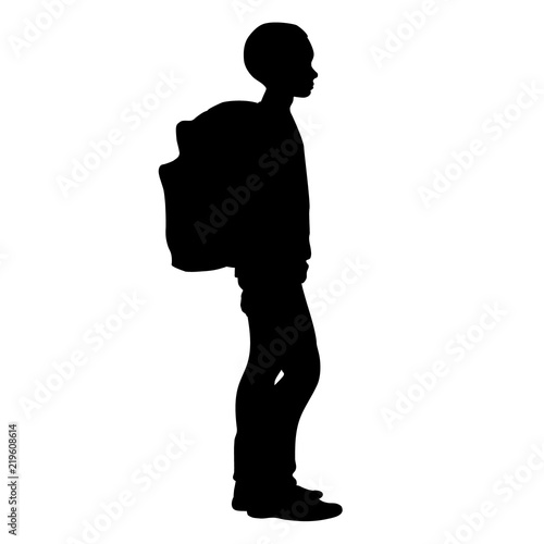 Boy stands with his school backpack  (isolated silhouette)