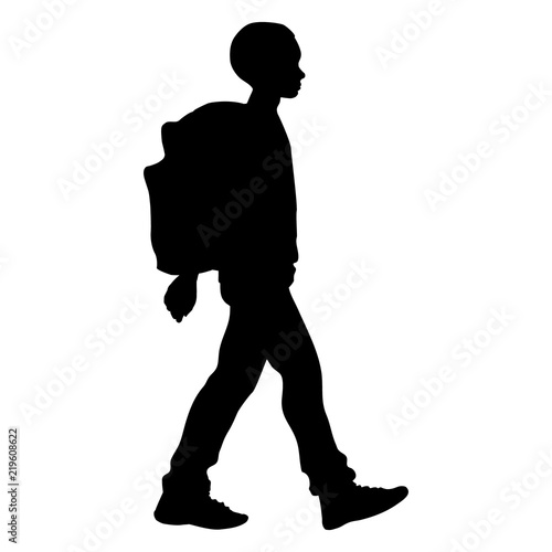 Boy goes  with his backpack to school (isolated silhouette)