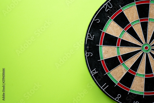 Target dart board on the green background, center point, head to target marketing and business success concept
