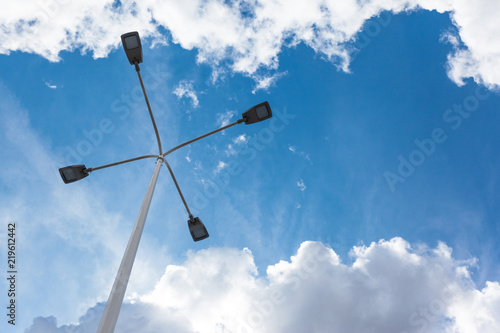 modern street lamp on a background of blue cloudy sky