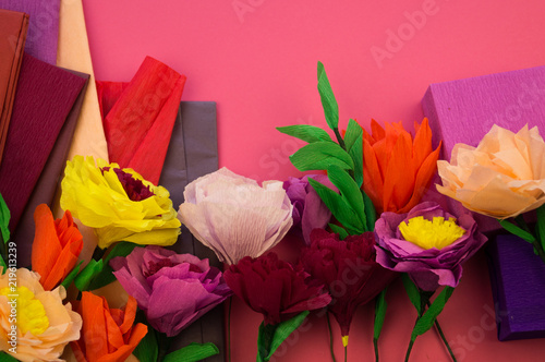 making crepe paper flowers on pink background photo