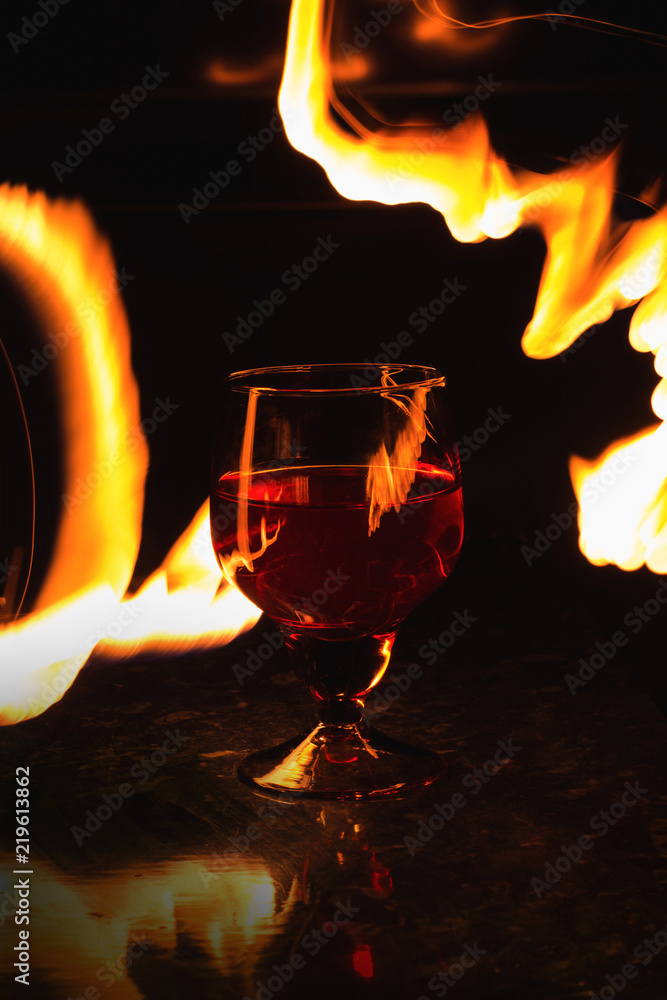 A glass of wine on a black background. Party club entertainment. A glass of wine on a black background. Party club entertainment.