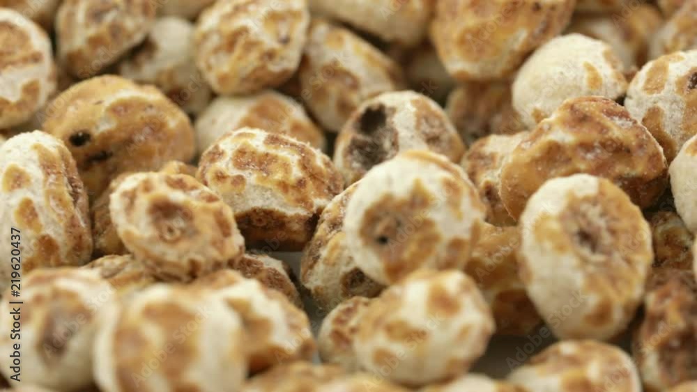 peeled tiger nuts, a rich source of resistant starch, rack focus on rotating background peeled tiger nuts, a rich source of resistant starch, rack focus on rotating background