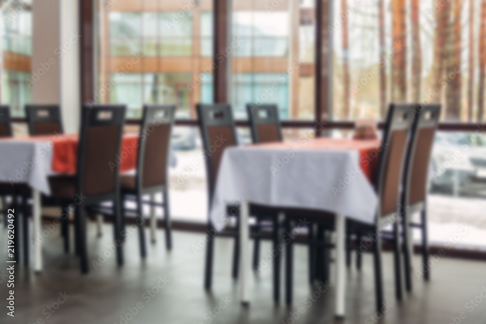 Blurred Background of dining tables and chairs in the restaurant. Light interior