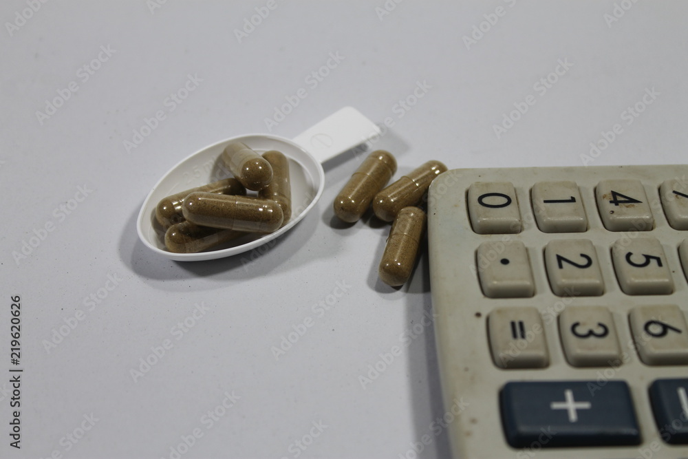 Calculator with medicine pills. Calculator with medicine pills.