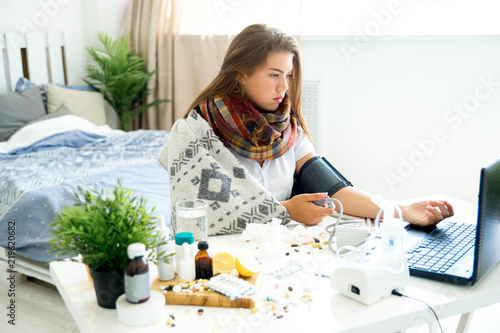 ill young girl with fever spending time at home