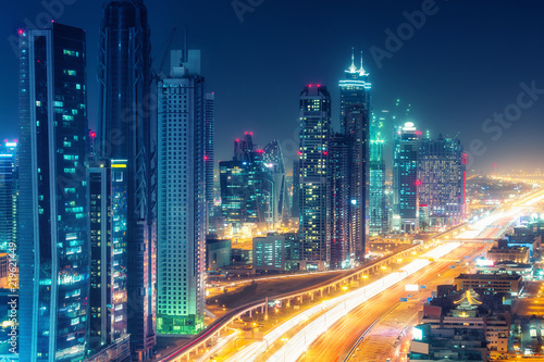 Scenic nighttime skyline of downtown Dubai  United Arab Emirates. Aerial view on highways and skyscrapers in the distance.