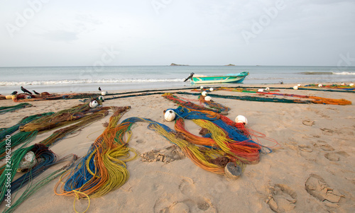 Konstfotografi Multi-colored fishing nets drying in the sun next to small fishing boat on Nilav