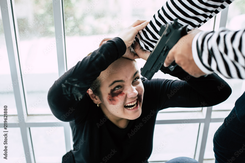 Thieves used a gun to intimidate the woman attacked her with a scar on his face.She was injured