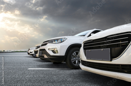 Several cars are neatly parked on the floor of the city square