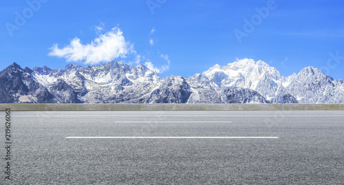 Highway and distant Jade Dragon Snow Mountain in Yunnan Province, China