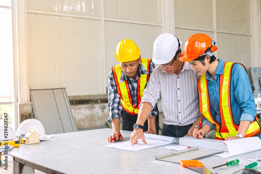 Engineers and architect are meeting to plan joint deals at construction sites.They have to work together to meet their needs customer in time. Engineers and architect are meeting to plan joint deals at construction sites.They have to work together to meet their needs customer in time.