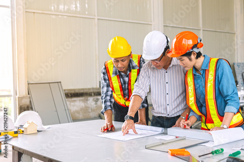 Engineers and architect are meeting to plan joint deals at construction sites.They have to work together to meet their needs customer in time.