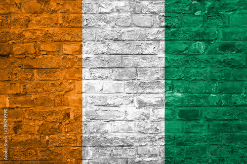 Flag of Cote d Ivoire over an old brick wall background  surface